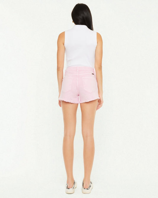 Person wearing a white sleeveless top and pink shorts on a white background