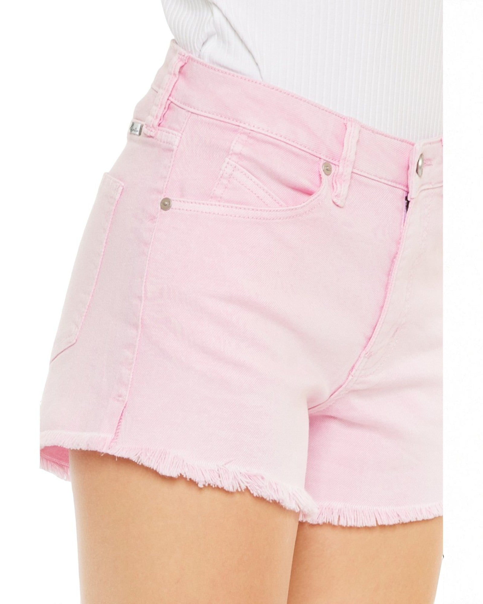 Pink denim shorts worn by a person on a white background