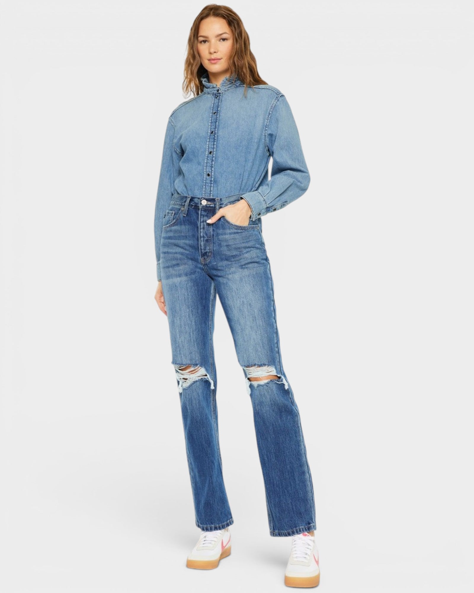 Person wearing a denim outfit with a white background