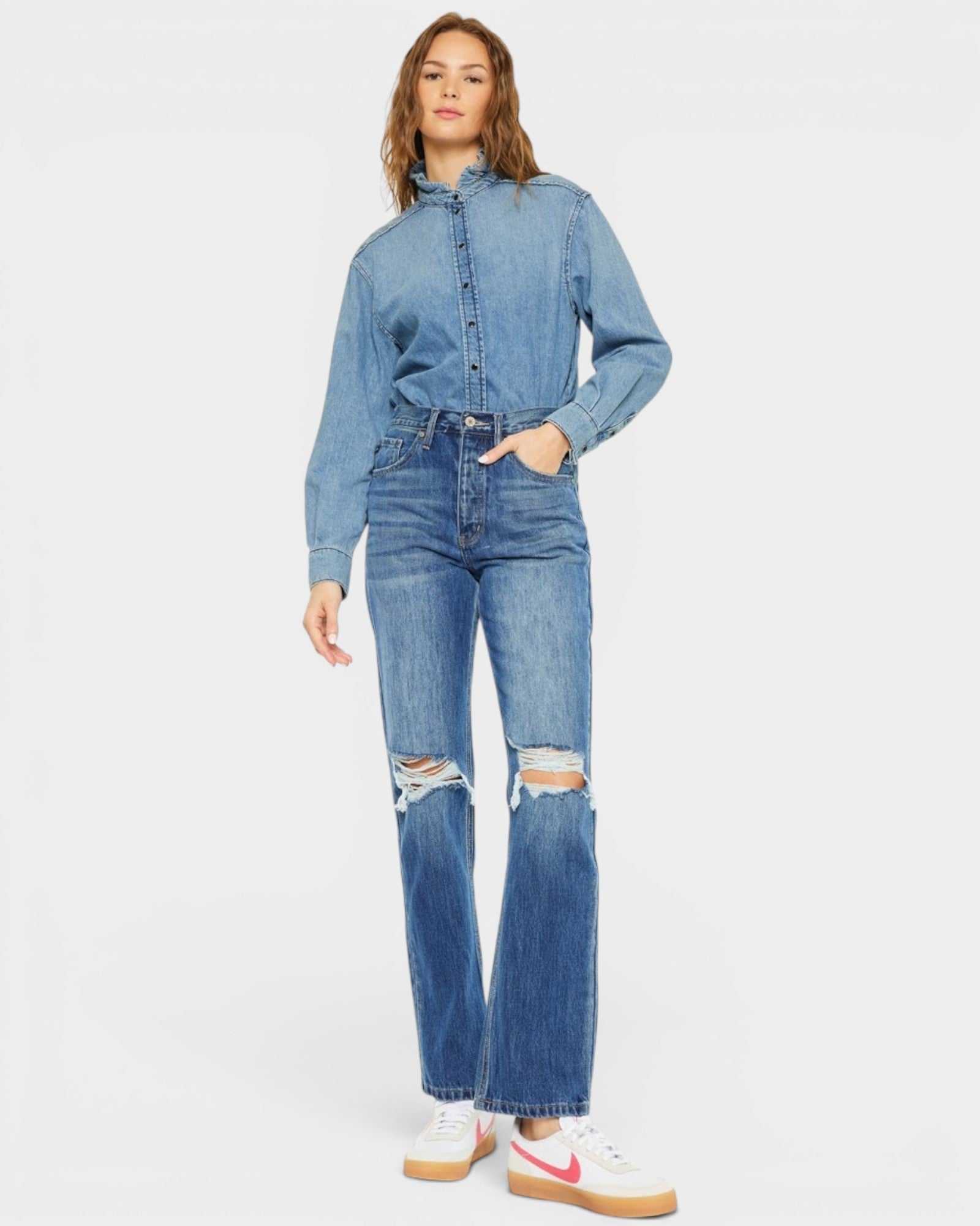 Woman wearing a denim outfit on a white background
