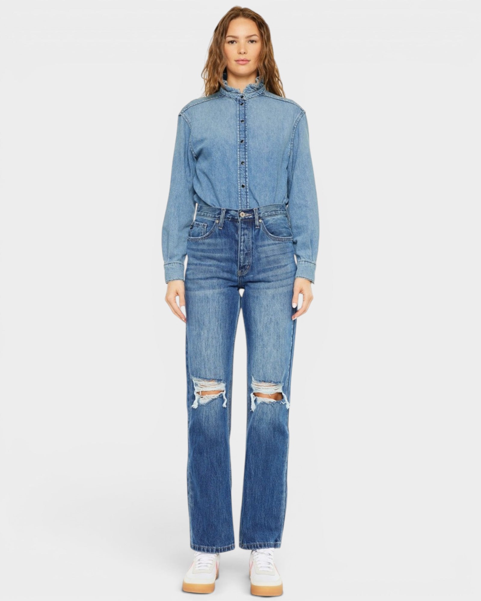 Person wearing a denim outfit with a white background