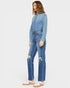 Woman wearing a denim jumpsuit on a white background