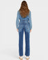 Person wearing a blue denim jumpsuit on a white background