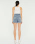 Person wearing light blue denim shorts on a white background