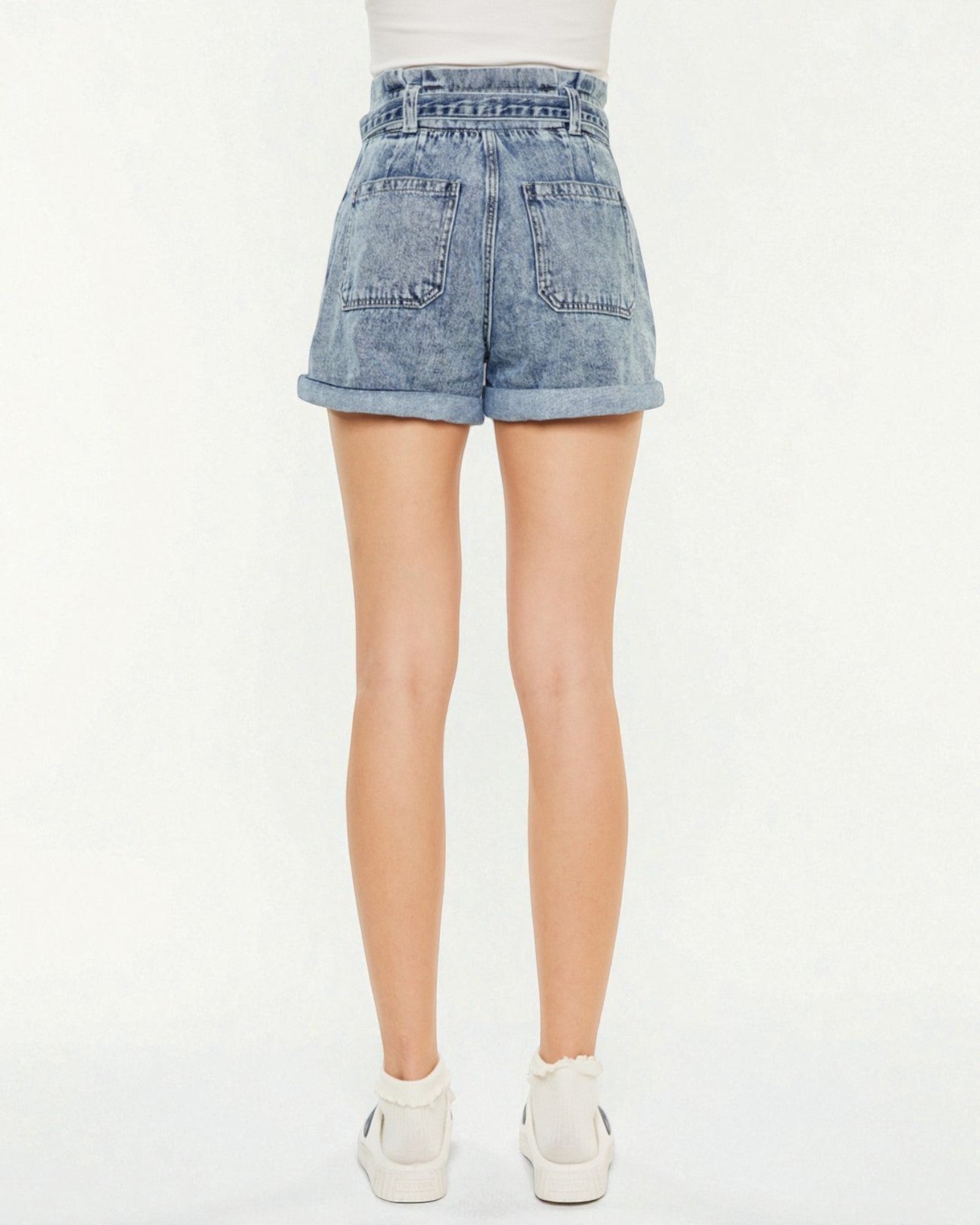 Light blue acid-wash denim shorts worn by a person on a white background