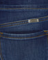 Close-up of blue denim fabric with a brand label.