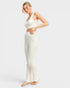 Woman wearing a white outfit on a plain background