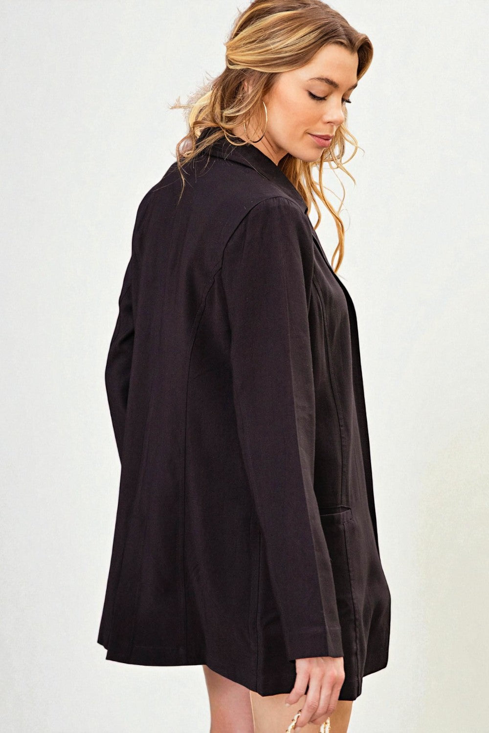 Woman wearing a black jacket on a white background