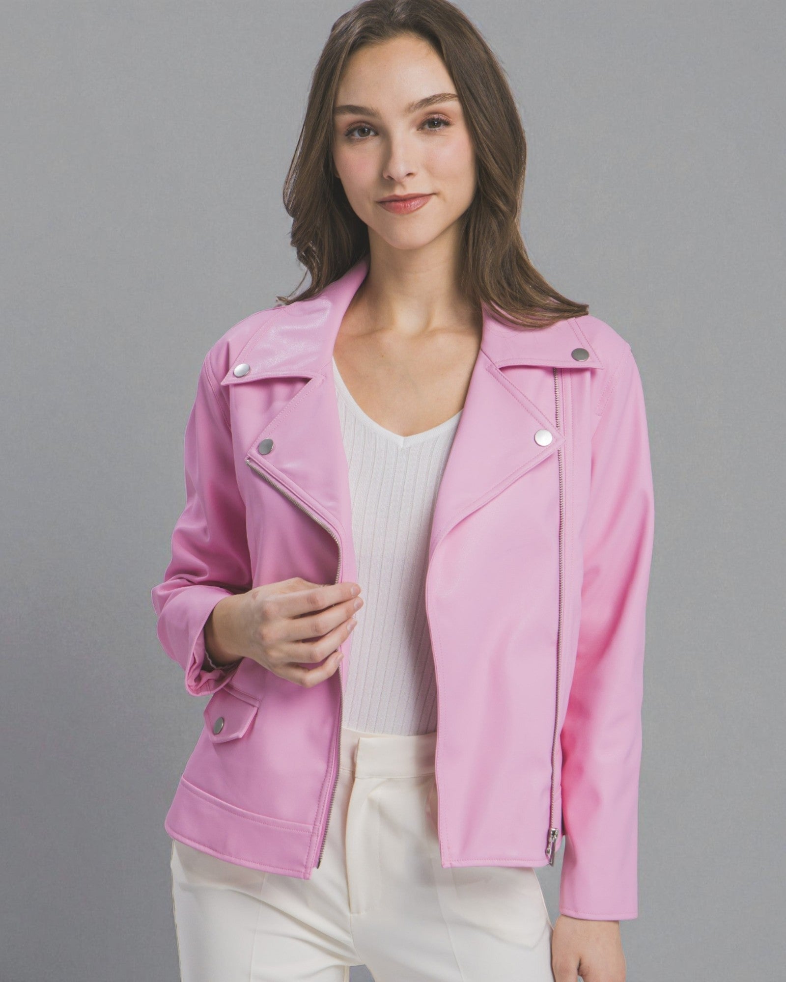 Woman wearing a pink jacket against a gray background