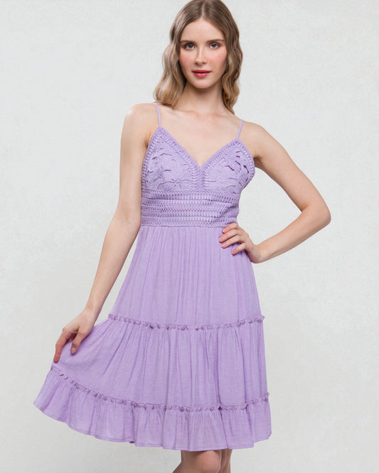 Woman wearing a purple dress on a light gray background