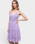 Woman wearing a purple dress against a white background