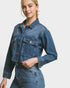 Woman wearing a blue denim jacket and pants on a white background