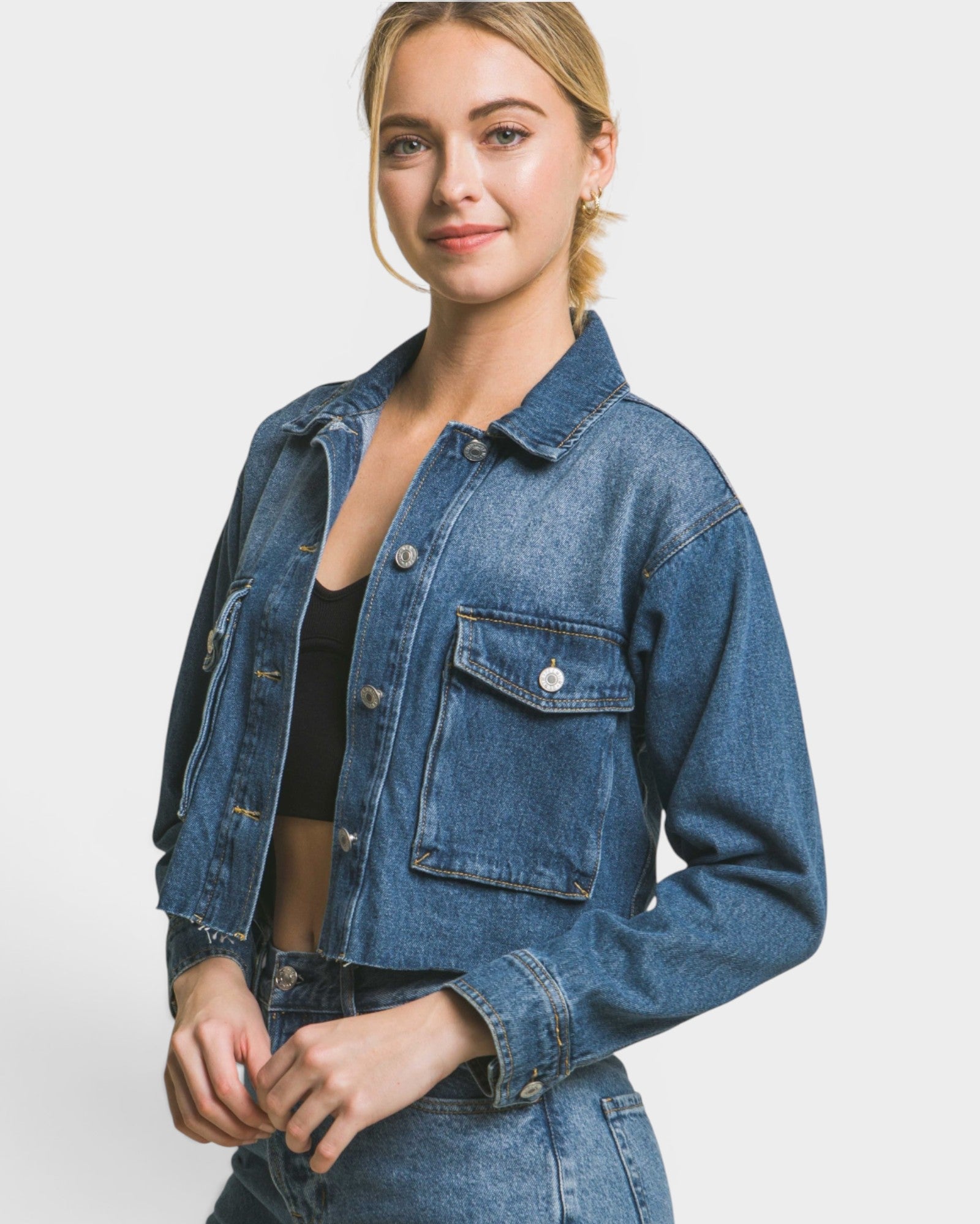Woman wearing a blue denim jacket on a white background
