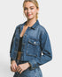 Woman wearing a blue denim jacket on a white background