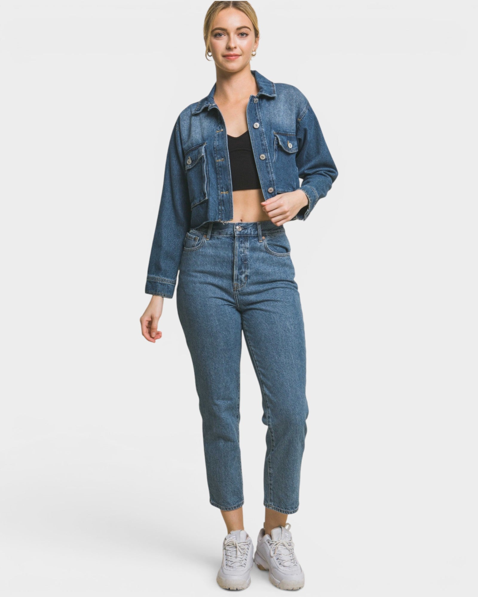 Person wearing a denim jacket and jeans on a white background