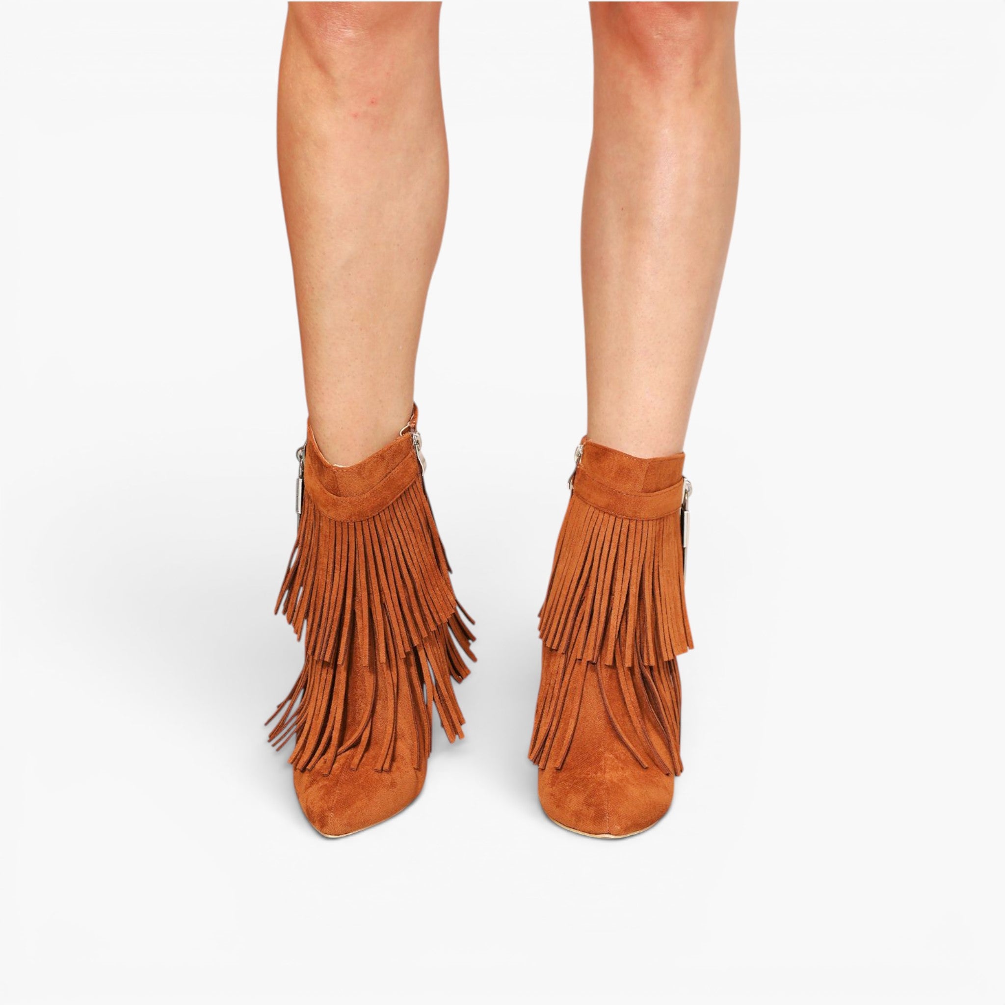A pair of women's ankle boots in a warm brown suede-like material, featuring multiple tiers of fringe and a block heel, shown on a model's feet against a light gray background.