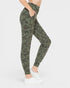 Camouflage leggings worn by a person on a white background
