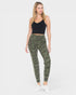 Woman wearing camouflage leggings and a black top on a white background