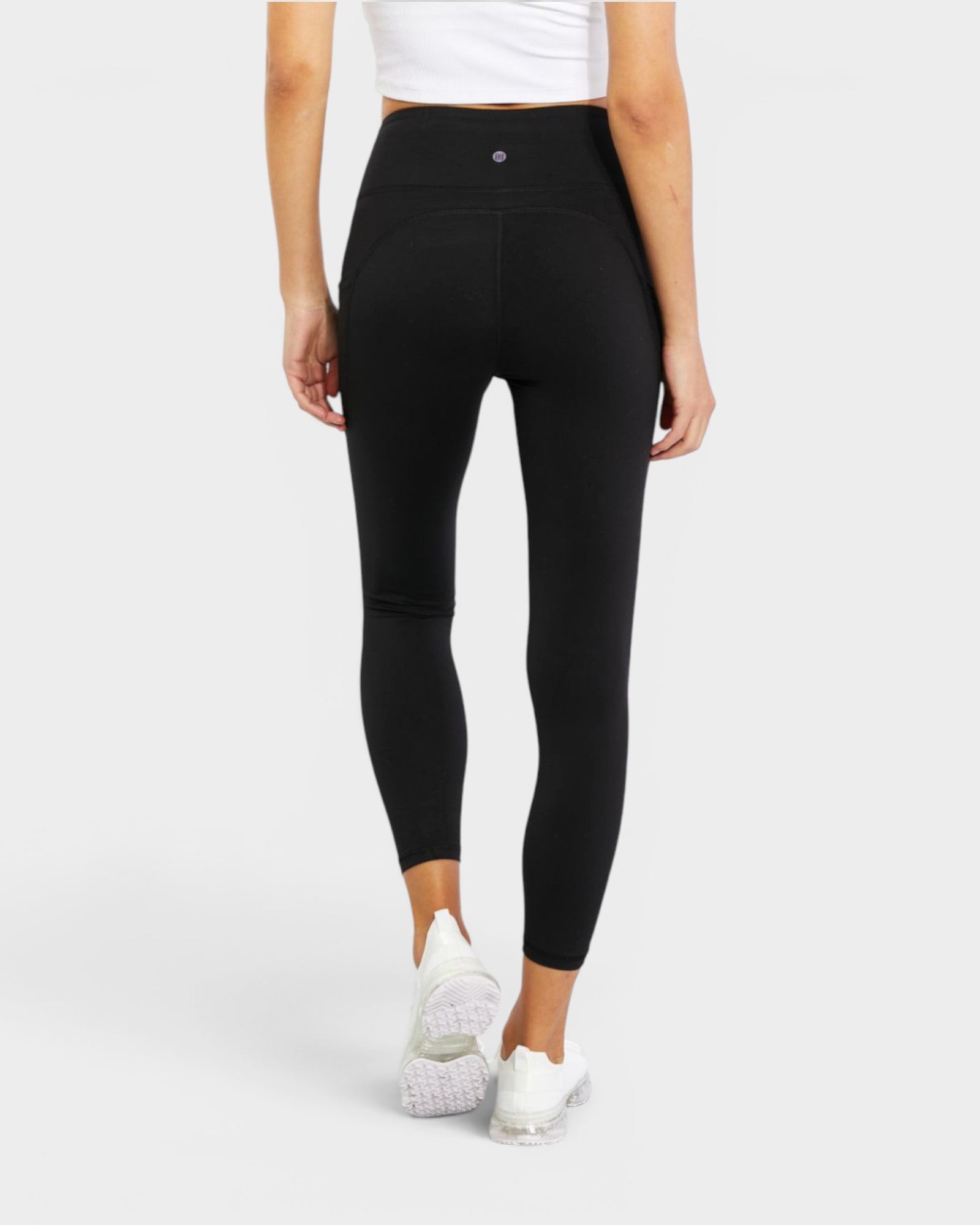 Person wearing black leggings on a white background