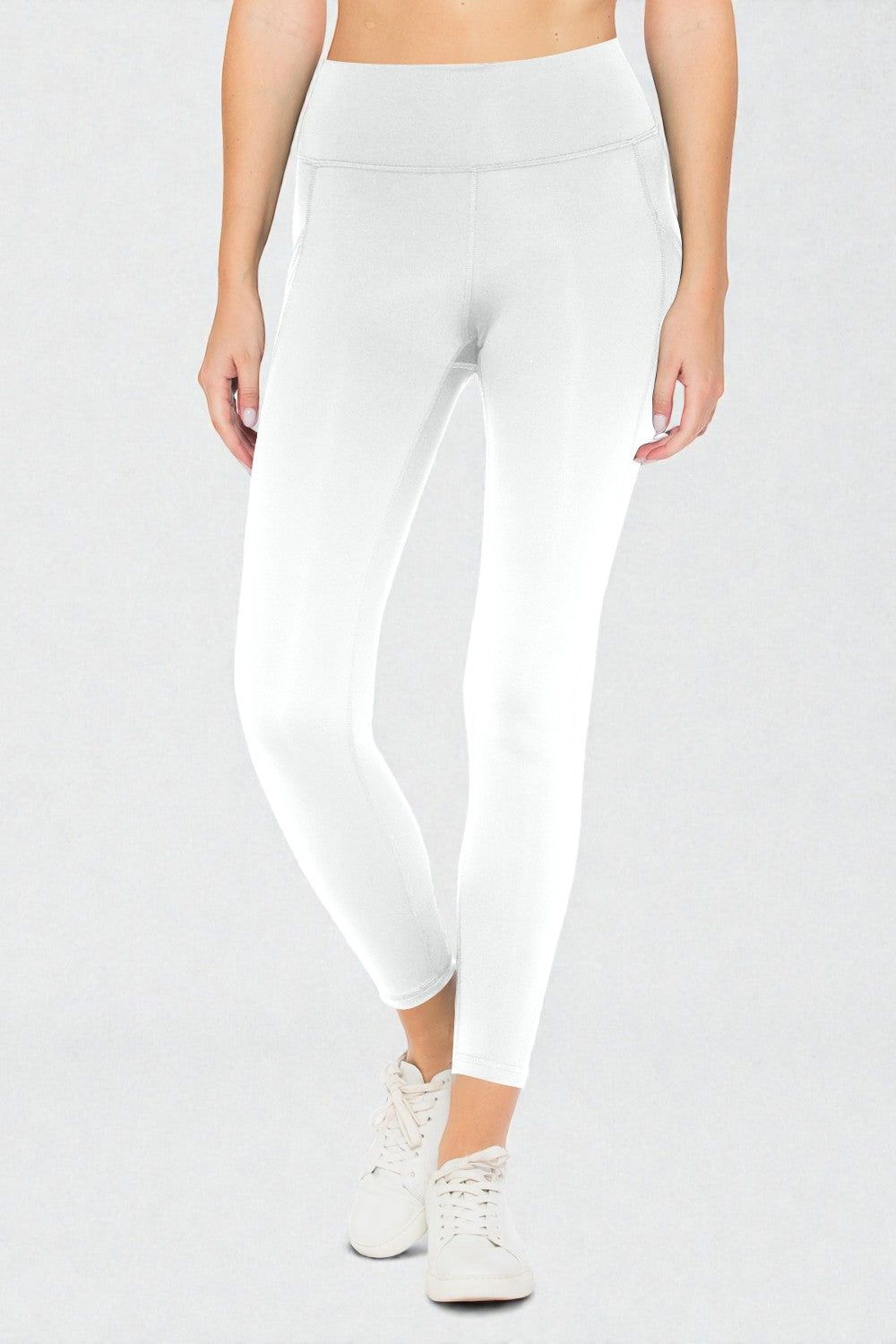 White leggings worn by a person on a light gray background