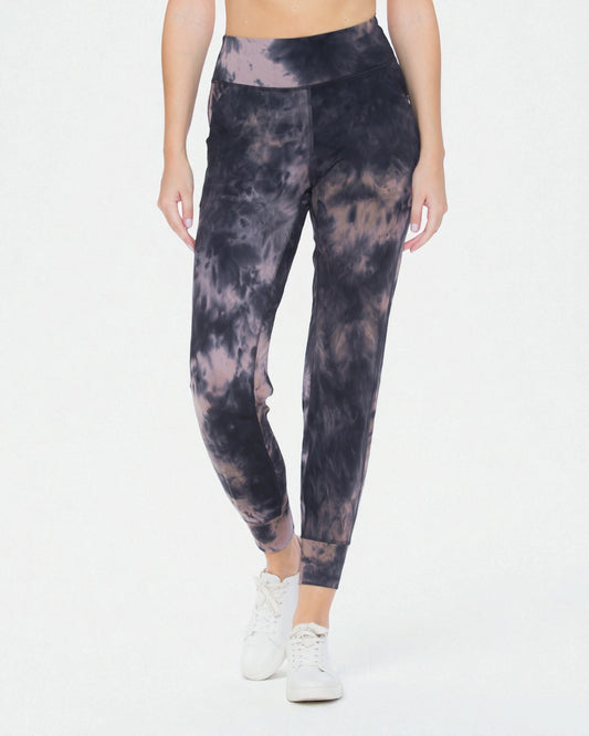 Person wearing tie-dye leggings on a white background