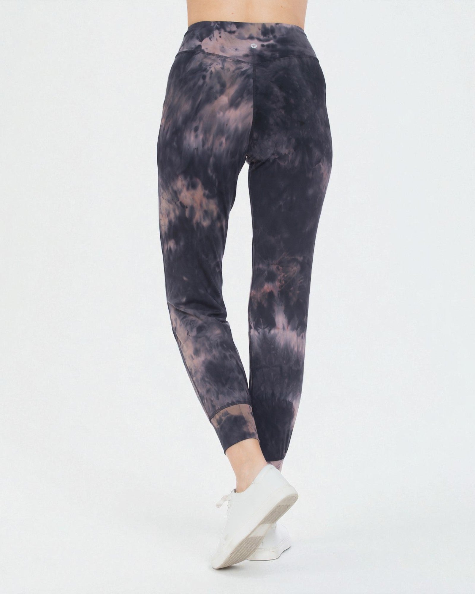 Tie-dye leggings worn by a person on a white background