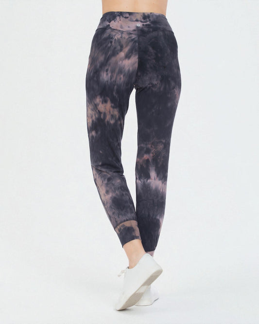 Tie-dye leggings worn by a person on a white background