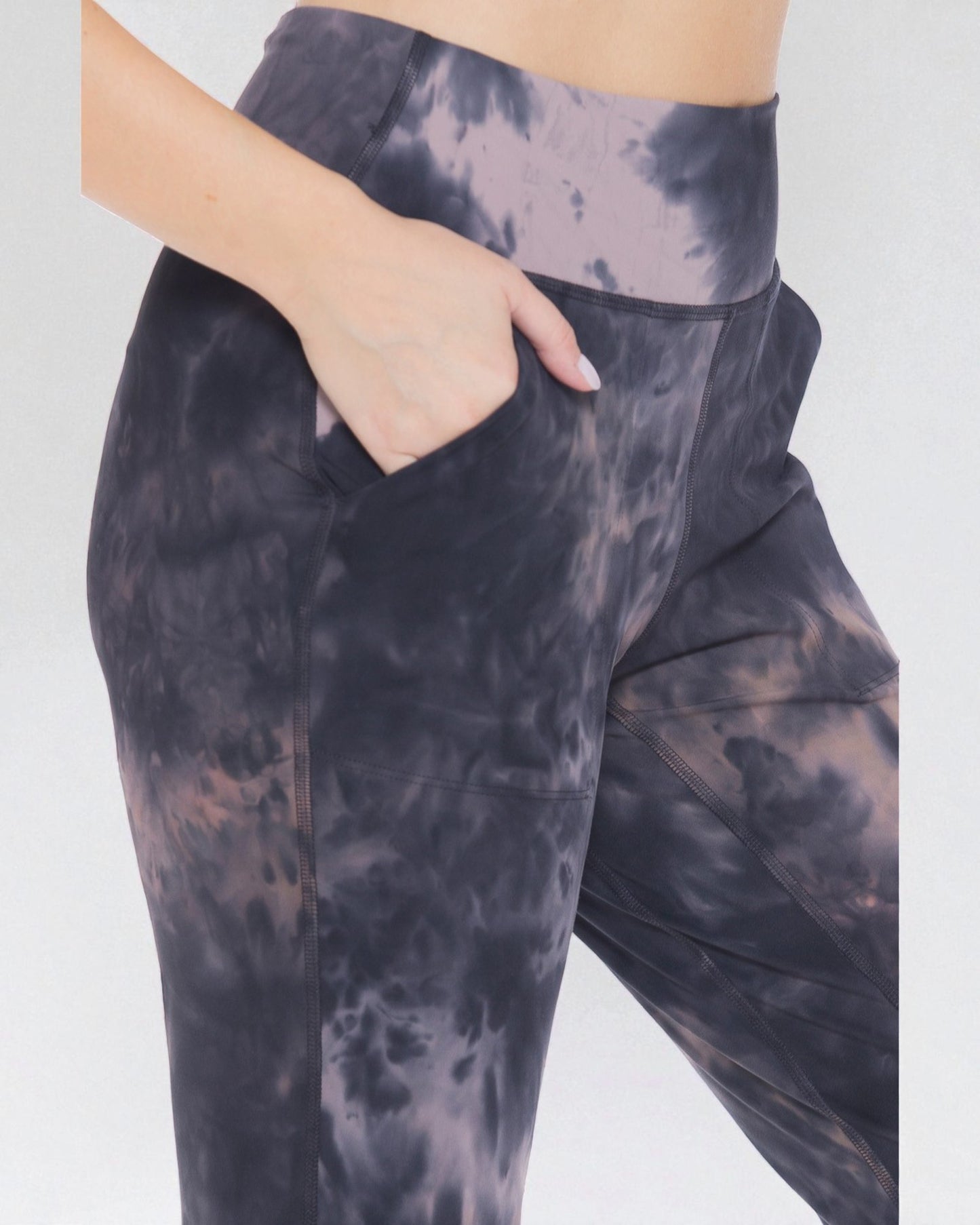Tie-dye leggings worn by a person on a white background