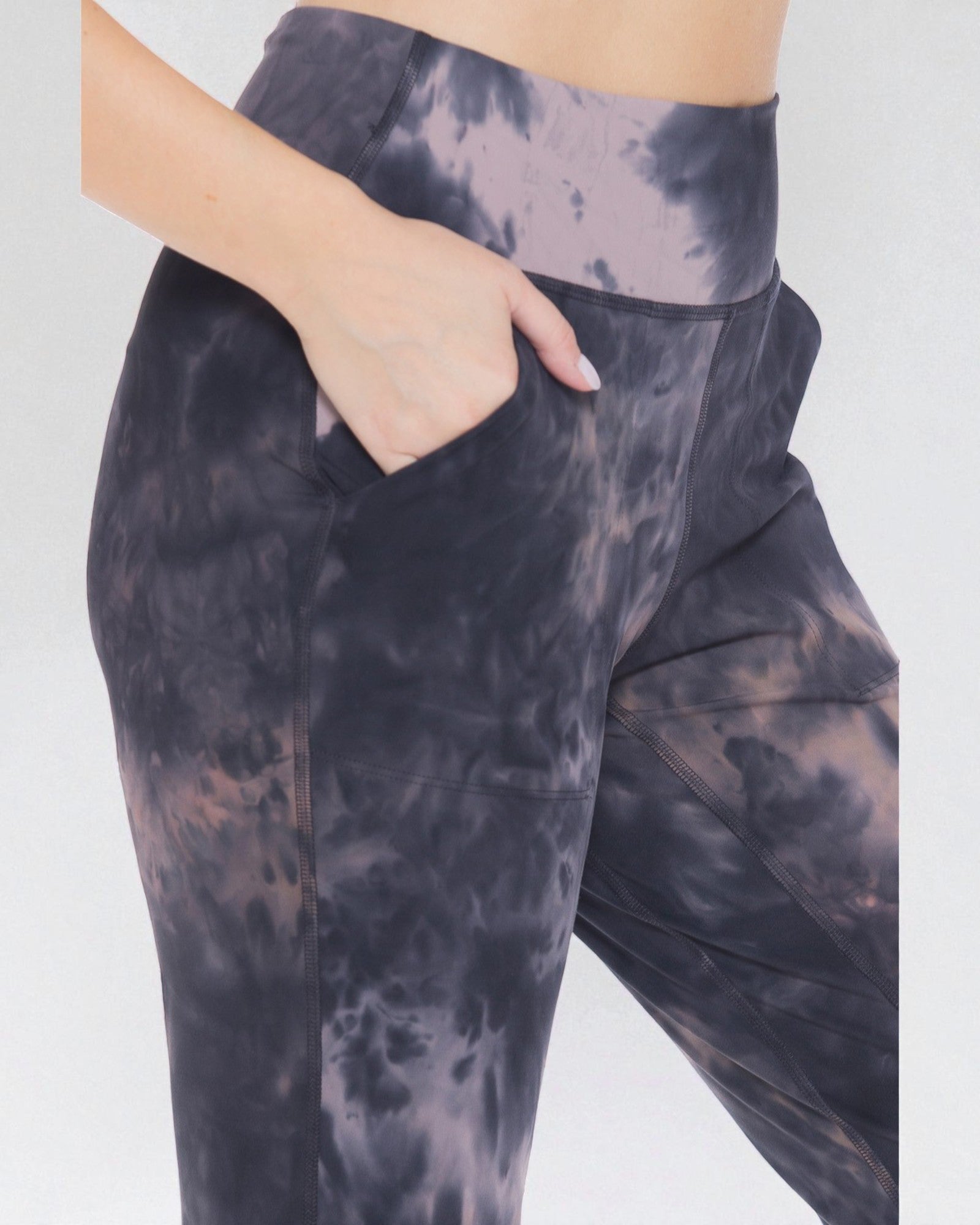 Tie-dye leggings worn by a person on a white background