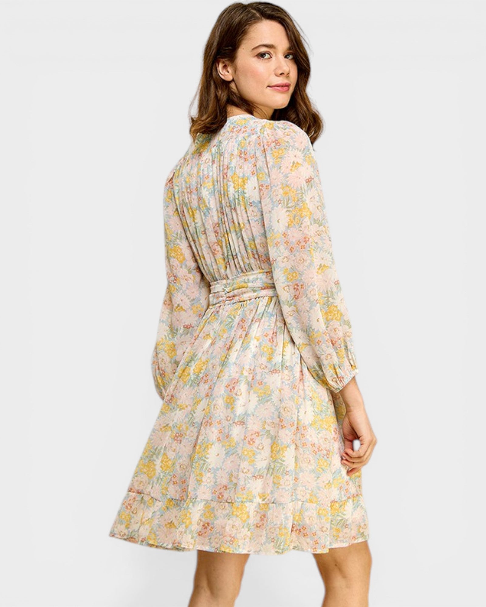 Woman wearing a floral dress on a white background
