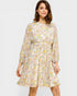 Woman wearing a floral dress on a plain background