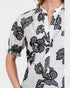 White blouse with black floral pattern on a white background