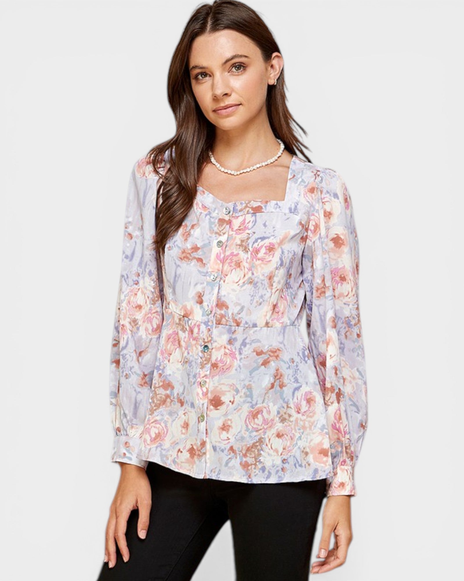 Woman wearing a floral blouse with a plain background