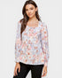 Woman wearing a floral blouse with a plain background