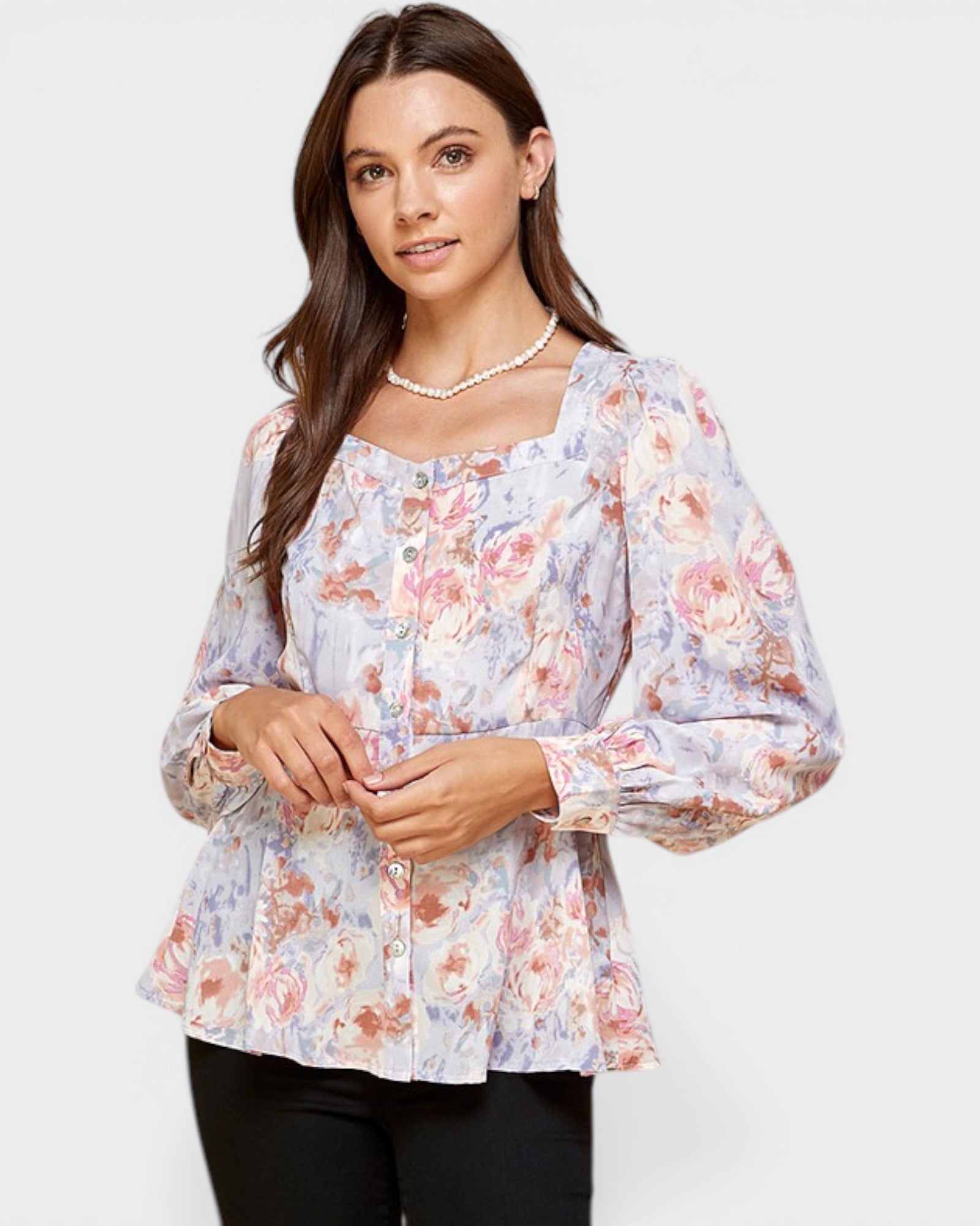 Woman wearing a floral blouse on a white background