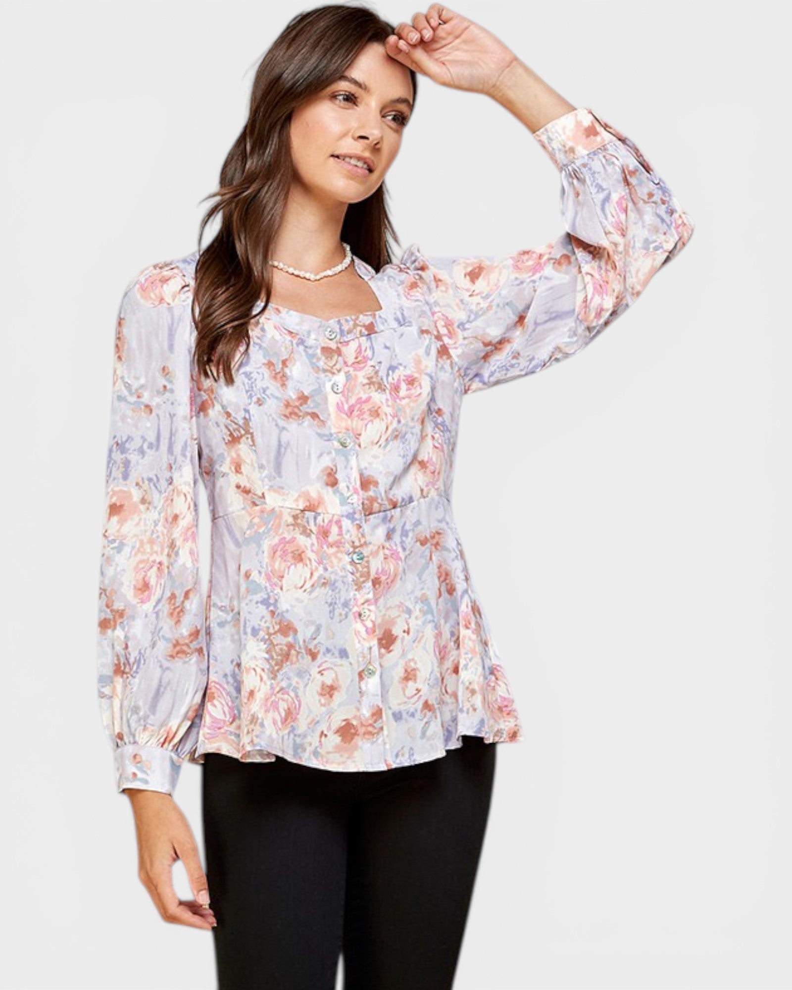 Woman wearing a floral blouse with a plain background