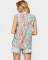 Woman wearing a sleeveless floral top and denim shorts on a white background