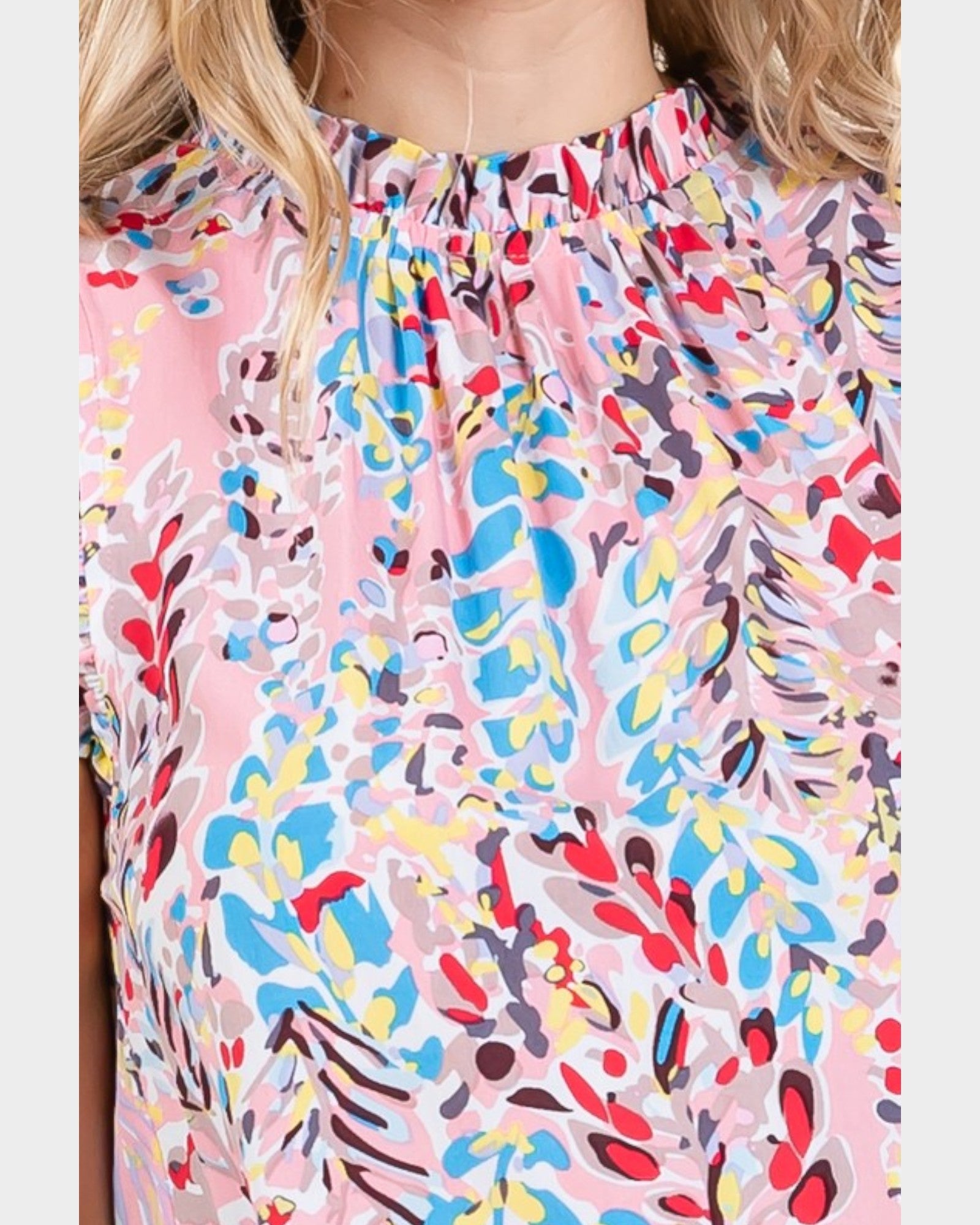 Colorful abstract patterned top worn by a person
