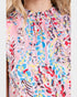 Colorful abstract patterned top worn by a person