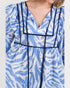 Blue and white patterned dress with black trim on a plain background