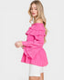 Woman wearing a pink off-shoulder top on a white background
