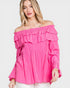 Woman wearing a bright pink off-shoulder top on a white background