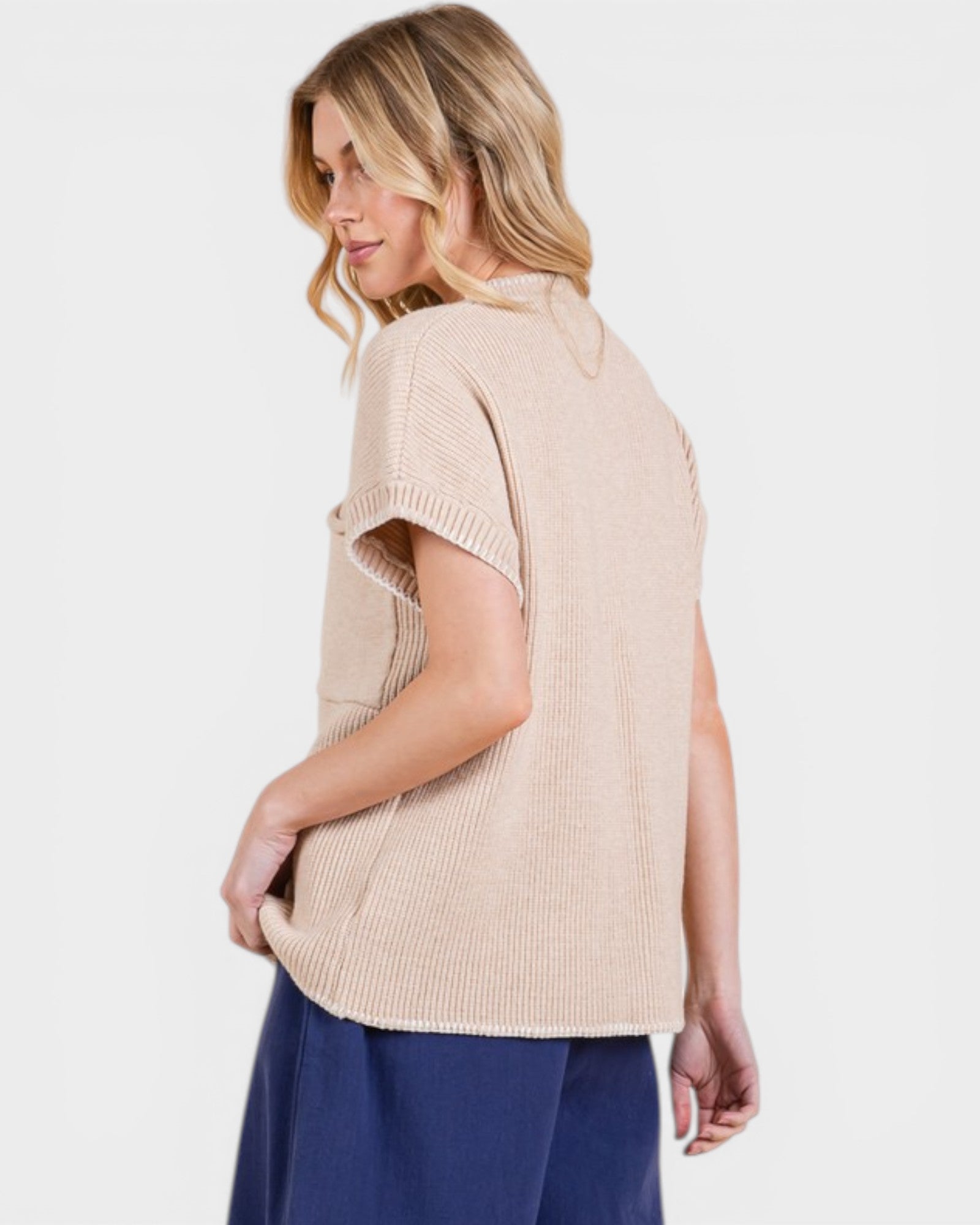 Woman wearing a beige short-sleeve top on a white background