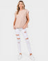Woman wearing a striped top and white ripped jeans on a white background
