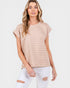Woman wearing a beige striped top and white jeans on a white background