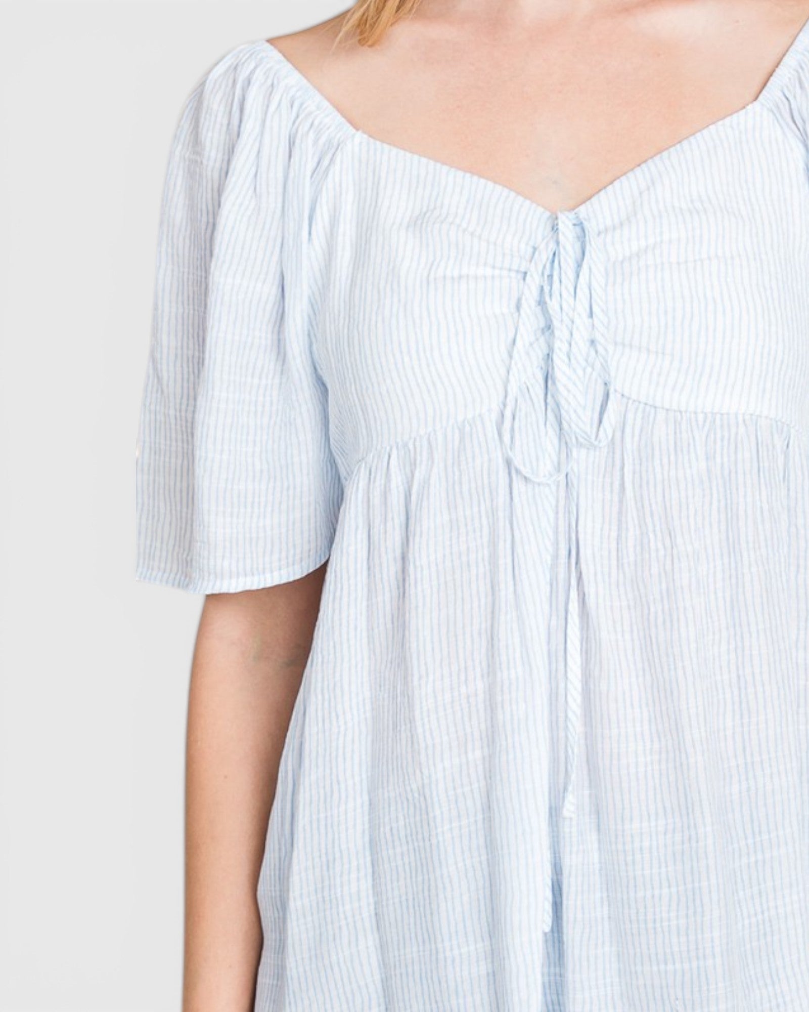 Light blue striped dress with a plain background
