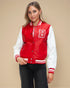 Woman wearing a red and white varsity jacket with a letter 'B' on a beige background