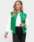 Woman wearing a green and white varsity jacket on a white background