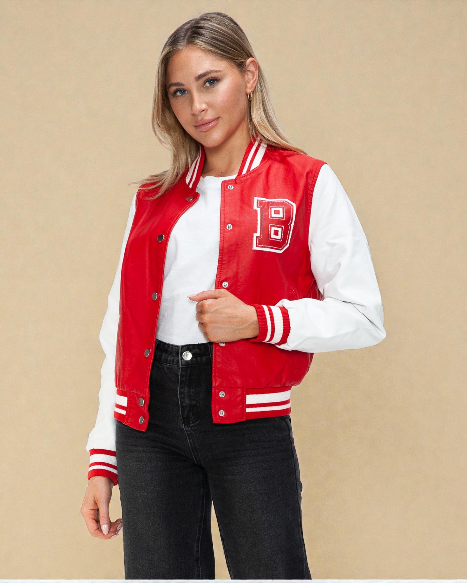 Woman wearing a red and white varsity jacket with a letter 'B' on a beige background