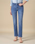 Person wearing blue jeans on a beige background